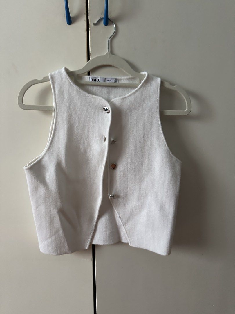 ZARA White Knitted Button-Up Tank Top (Category: Sleeveless) located in Cebu City. Submitted by lavitify (Listing ID 1467286202, Image 2). Description: - Brand: ZARA. Size Small - Style: Sleeveless knit crop top with round neck and decorative silver buttons - Color: Crisp white - Material: Soft, stretchy ribbed knit - Fit: Cropped (perfect for high-waisted bottoms) - Condition: Worn only thrice, like new - rfs: used thrice, not my style anymore .