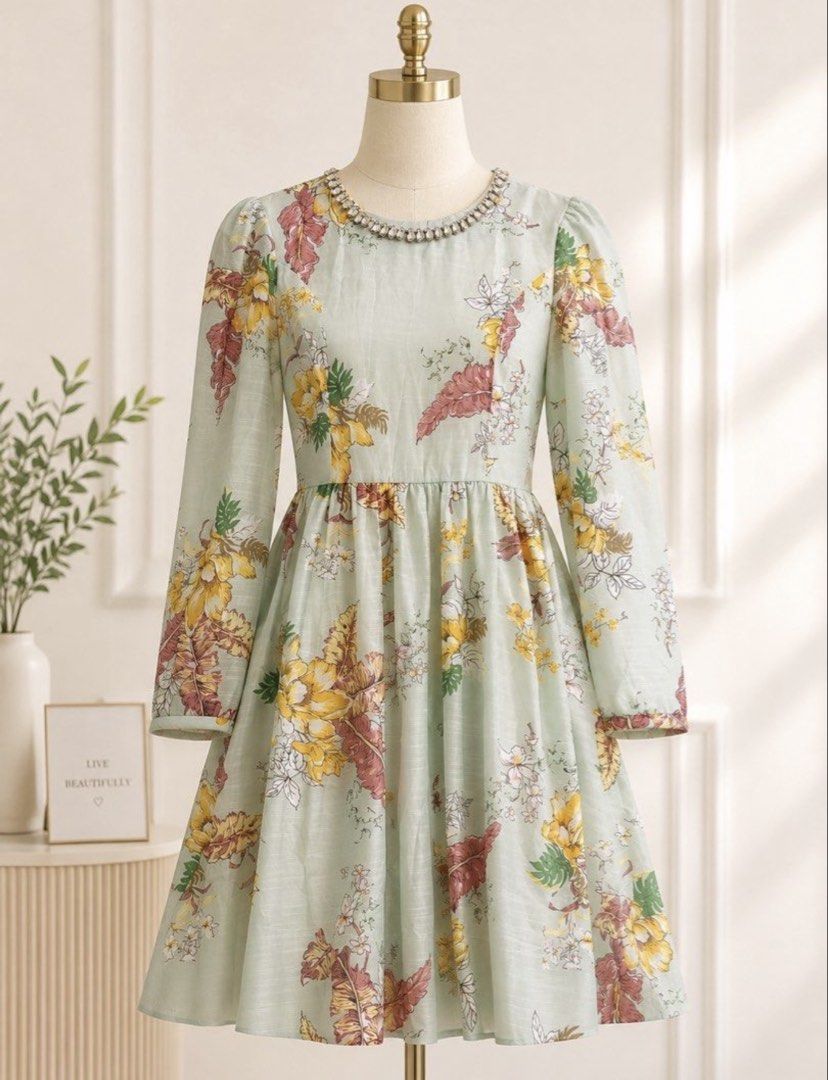 Zim Insp Dress (Category: Dresses) located in Manila. Submitted by theopal (Listing ID 1467197387, Image 1). Description: * Sage-green base with a vibrant yellow, red, orange, and white floral and leaf print. * Rounded with a rhinestone-embellished collar. * Long sleeves with gathered shoulders and cuffs. * Fit-and-flare design with a fitted bodice and knee-length A-line skirt. * Cut Tag *color may vary due to lighting.