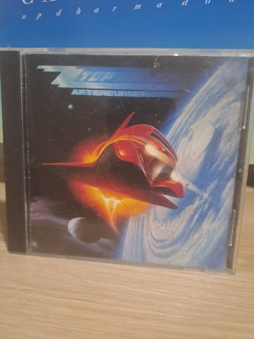 ZZ Top Afterburner Audio CD (Category: CDs & DVDs) located in Las Pinas. Submitted by cobieshop (Listing ID 1467324224, Image 1). Description: - Artist/Album: ZZ Top - Afterburner CD - Format: Standard jewel case with iconic 80s spaceship cover art - Condition: Minor surface scratches on the case from storage - Playback: Disc plays fine without issues - Perfect for: Classic rock music collections.