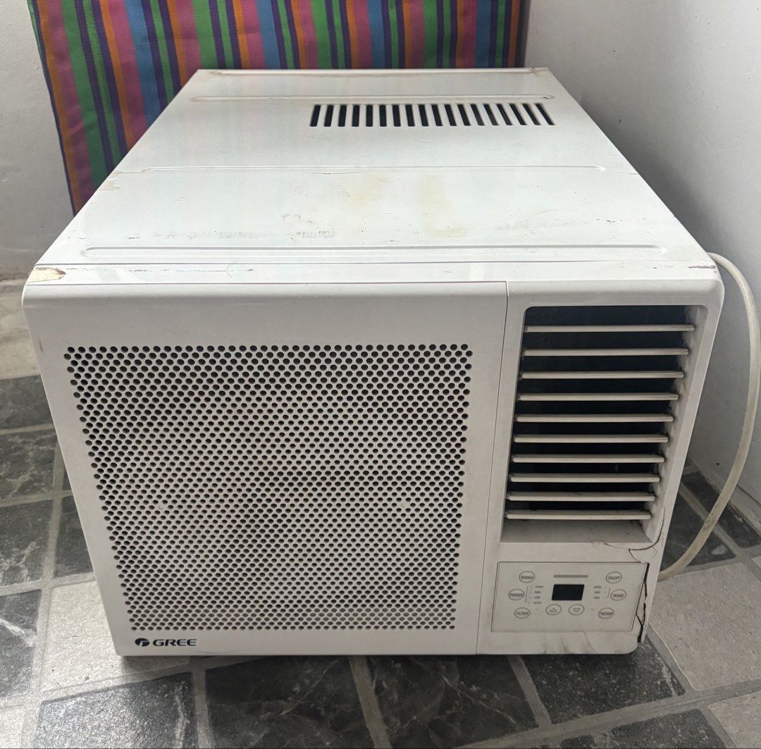 1HP Gree Inverter Window Air Conditioner Unit (Category: Air Conditioning and Heating) located in Manila. Submitted by dgzmnmariaeunice (Listing ID 1467364591, Image 1). Description: - Brand/Type: White Gree window air conditioner - Size: Standard compact size, perfect for room cooling - Controls: Digital control buttons with a perforated front grille - Airflow: Adjustable louvers located on the right side - Power: Attached power cord on the righ