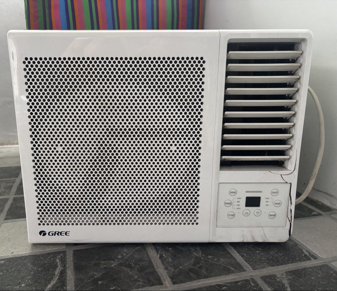 1HP Gree Inverter Window Air Conditioner Unit (Category: Air Conditioning and Heating) located in Manila. Submitted by dgzmnmariaeunice (Listing ID 1467364591, Image 2). Description: - Brand/Type: White Gree window air conditioner - Size: Standard compact size, perfect for room cooling - Controls: Digital control buttons with a perforated front grille - Airflow: Adjustable louvers located on the right side - Power: Attached power cord on the righ