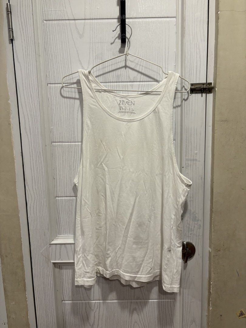 21 Men White Tank Top Size L (Category: Sleep and Loungewear) located in Mandaluyong City. Submitted by shopwithjuu (Listing ID 1467448585, Image 1). Description: White 21 Men sleeveless tank top in size Large. Made of soft, breathable cotton with a classic scoop neck. Great for everyday wear or layering. PM for questions!.