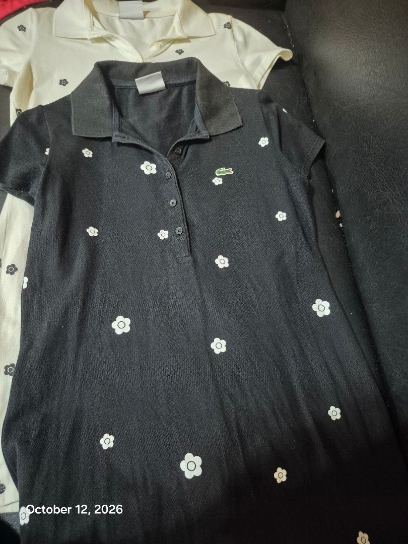 2 pcs LACOSTE Mary Quant japan (Category: Dresses) located in Cavite. Submitted by jannahjasmin (Listing ID 1467379045, Image 2). Description: - Black Lacoste polo shirt - White floral pattern - Classic collar - Short sleeves - Button-down front - Lacoste logo - Regular fit - Perfect for casual wear.