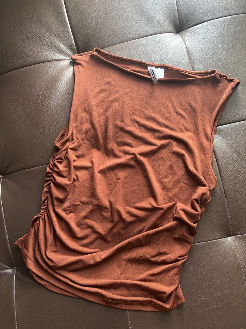 3 H&M Tops Bundle (Category: Sleeveless) located in Taguig. Submitted by chicca_nicca (Listing ID 1467403168, Image 2). Description: 3 H&M Tops 1. Brown tank top from H&M Divided. Size M (165/96A). Ruched detailing down the sides. Scoop neckline, sleeveless cut. Stretchy fabric, snug fit. Simple basic piece for daily outfits, easy to match with jeans or skirts. 2. Black ruffled flowy top EU 34/ Small 3. boho flowy top with 3/4 sleeves EUR M.