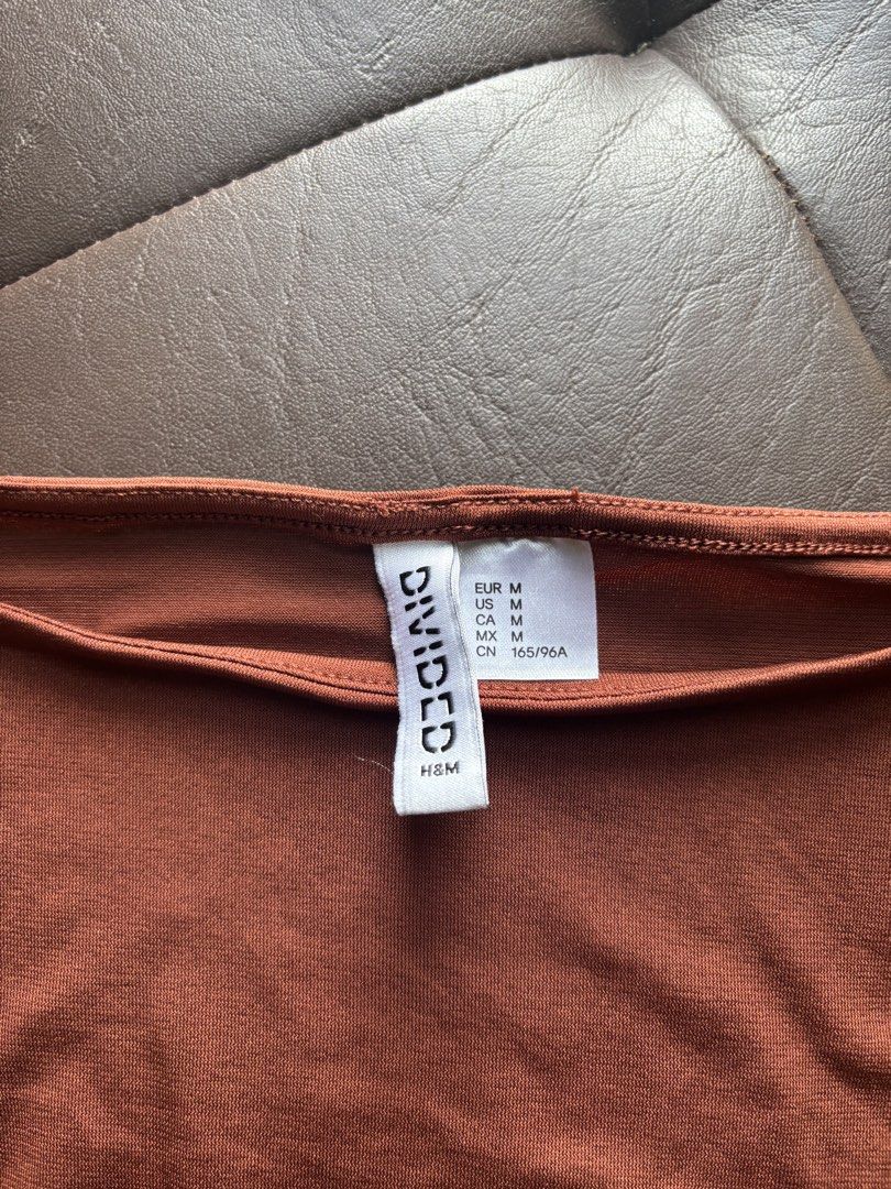 3 H&M Tops Bundle (Category: Sleeveless) located in Taguig. Submitted by chicca_nicca (Listing ID 1467403168, Image 3). Description: 3 H&M Tops 1. Brown tank top from H&M Divided. Size M (165/96A). Ruched detailing down the sides. Scoop neckline, sleeveless cut. Stretchy fabric, snug fit. Simple basic piece for daily outfits, easy to match with jeans or skirts. 2. Black ruffled flowy top EU 34/ Small 3. boho flowy top with 3/4 sleeves EUR M.