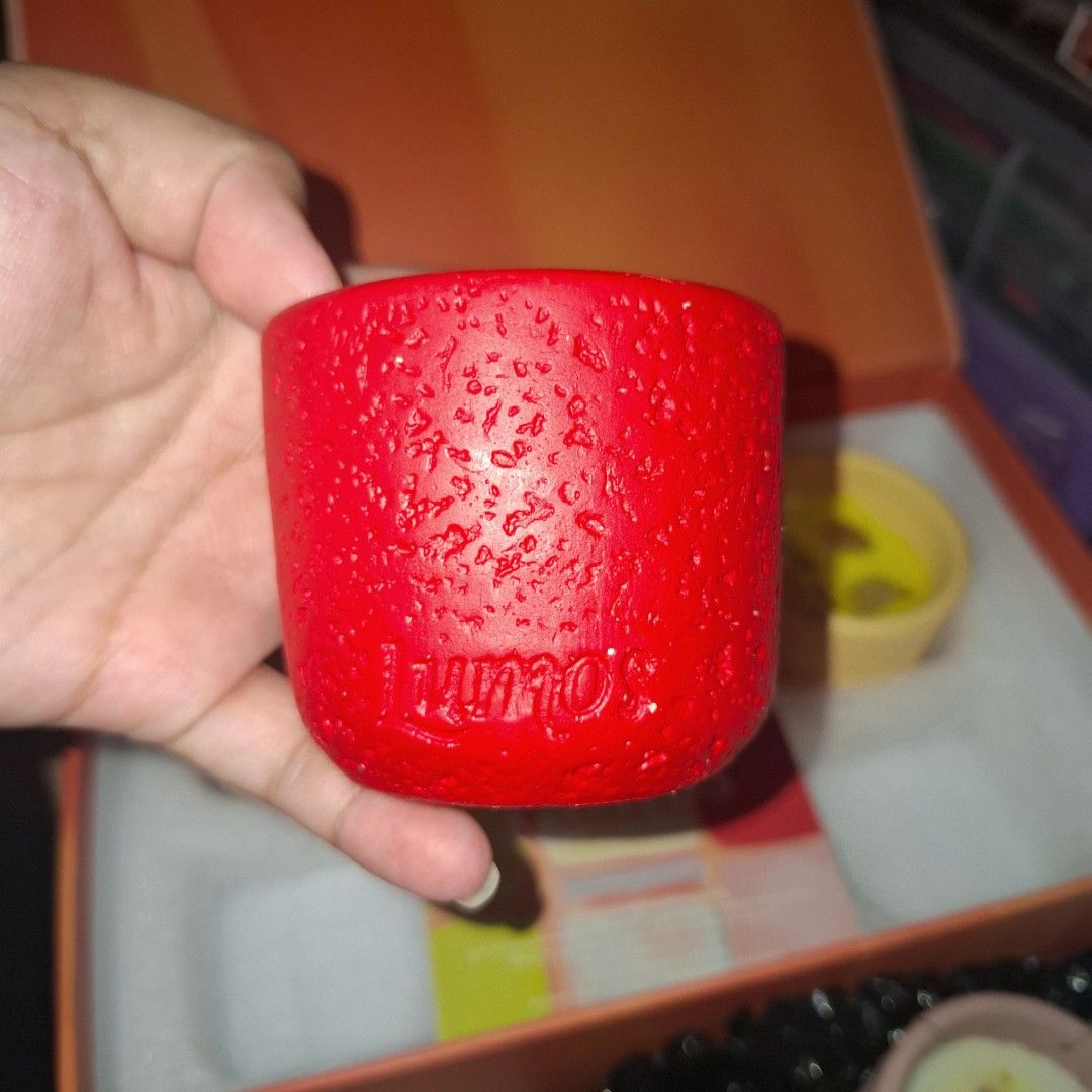 3pcs Aromatherapy Scented Candle Set (Category: Home Fragrance) located in Quezon City. Submitted by an.marie (Listing ID 1467418382, Image 3). Description: - Brand: Lumos - Product: Aromatherapy Scented Candle Gift Set - Inclusion: 3 colorful textured pots with yellow soy wax and embedded stones - Material: Soy wax blend infused with essential oils - Packaging: Comes in an elegant orange gift box with a branding card - Condition: Brand new, unus