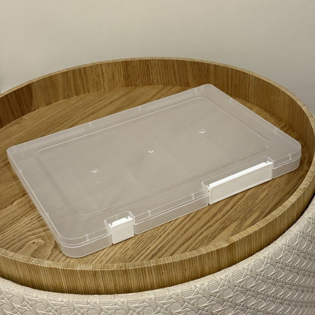 A5 Clear Plastic Document Storage Box Organizer with White Latches (Category: Storage Boxes & Baskets) located in Marikina City. Submitted by lovegoeson (Listing ID 1467475728, Image 1). Description: - Type: Clear plastic flat storage box - Size: Approx. 25cm in length - Features: Slim, stackable design with secure white snap closures - Condition: Excellent, no cracks or major scratches - Best for: Organizing stationery, papers, and small items.