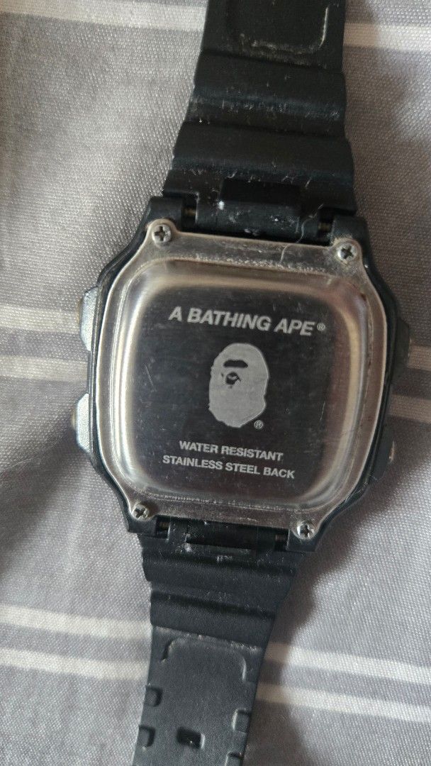 A Bathing Ape Bape Digital Watch (Category: Men's Watches) located in Mandaluyong City. Submitted by ohayouclub (Listing ID 1467369106, Image 3). Description: - Brand: A Bathing Ape (BAPE) - Color: Classic All-Black - Material: Durable square resin case and matching strap - Details: Iconic Bape branding on the face, strap, and engraved stainless steel case back - Closure: Standard pin buckle - Style: Streetwear staple, perfect for everyday wear -