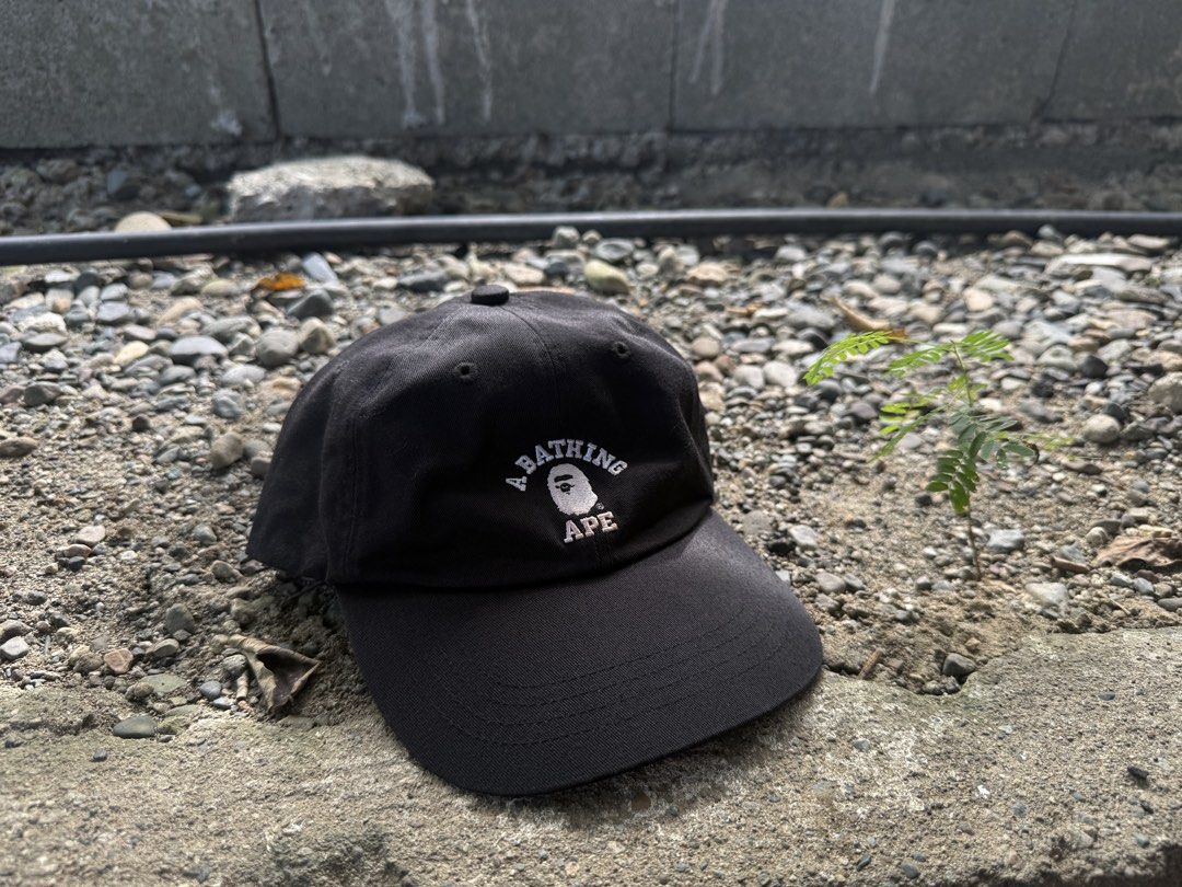 A Bathing Ape Black Baseball Cap (Category: Caps & Hats) located in Burgos, Ilocos Norte. Submitted by copthrift (Listing ID 1467371482, Image 1). Description: - 100% authentic BAPE baseball cap, made in Japan - Color: Classic Black with white embroidered A Bathing Ape logo - Material: 100% durable cotton - Features: Curved brim and adjustable back strap for a custom fit - Authenticity: Includes iconic 'World Gone Mad' interior branding and gold 
