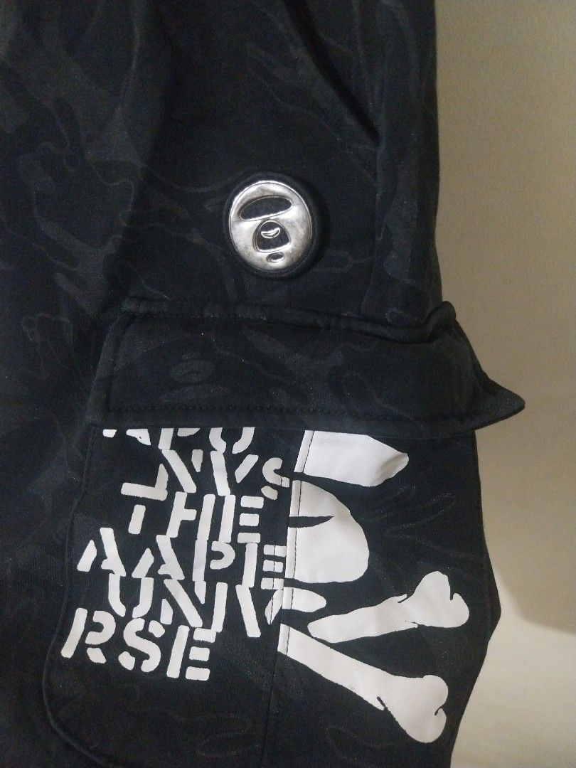 Aape Authentic Black Camo Cargo Shorts (Category: Shorts) located in Davao. Submitted by thegraildept2026 (Listing ID 1467547897, Image 3). Description: - Brand: Aape - Color: Black with subtle tonal camo print - Features: White graphic prints on hem and back pocket - Details: Metal Aape logo button, side cargo pockets, and Velcro patch with Aape text - Fit/Style: Drawstring eyelets along waistband, casual streetwear piece.