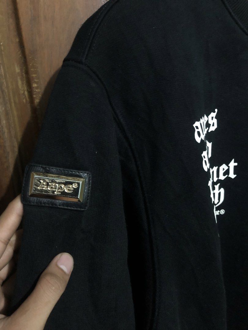 AAPE By A Bathing Ape Black Double Sleeve Sweatshirt (Category: Coats, Jackets and Outerwear) located in Quezon City. Submitted by yeahsource222 (Listing ID 1467530431, Image 3). Description: - Brand: AAPE (By A Bathing Ape) - Color: Black with gold details - Design: Layered short-sleeve overlay on long sleeves - Graphics: Gold foil AAPE text on front, large ape head skull logo on back, and 'apes and planet earth' lettering on chest - Details: Go