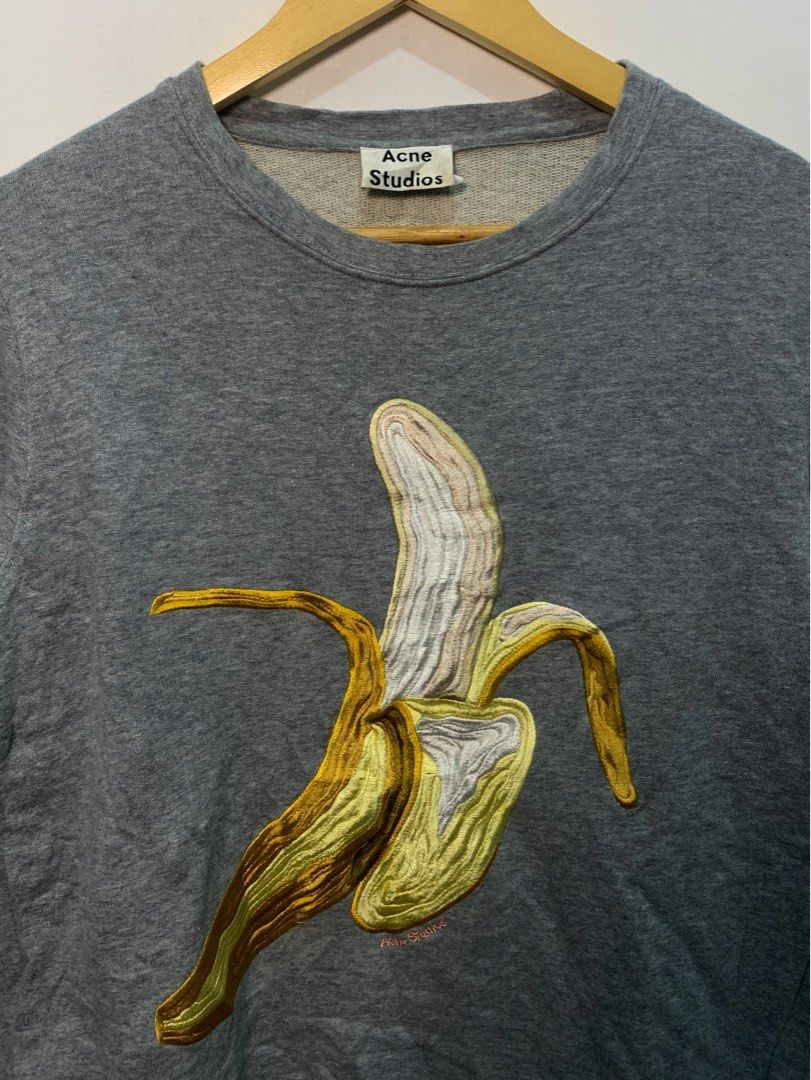 Acne Studios Grey Banana Embroidered Sweatshirt (Category: Longsleeves) located in Davao. Submitted by legitseller1111 (Listing ID 1467469368, Image 2). Description: - Brand: Acne Studios - Color: Grey - Material: Heavyweight cotton - Design: 3D embroidered banana graphic with subtle branding - Fit: Classic crewneck with long sleeves - Condition: Clean interior label intact, solid everyday wear -No issue/s -Excellent condition .