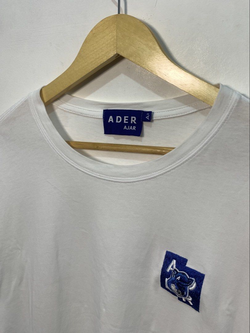 Ader Error White Logo Patch T-shirt Size A2 (Category: Tshirts & Polo Shirts ) located in Davao. Submitted by legitseller1111 (Listing ID 1467464161, Image 2). Description: - Brand: Ader Error - Color: White with blue embroidered chest patch - Size: A2 - Material: 100% premium cotton - Details: Classic crew neck, short sleeves, includes original care and style tags - Condition: Clean and ready for everyday casual wear -Excellent Condition -No iss