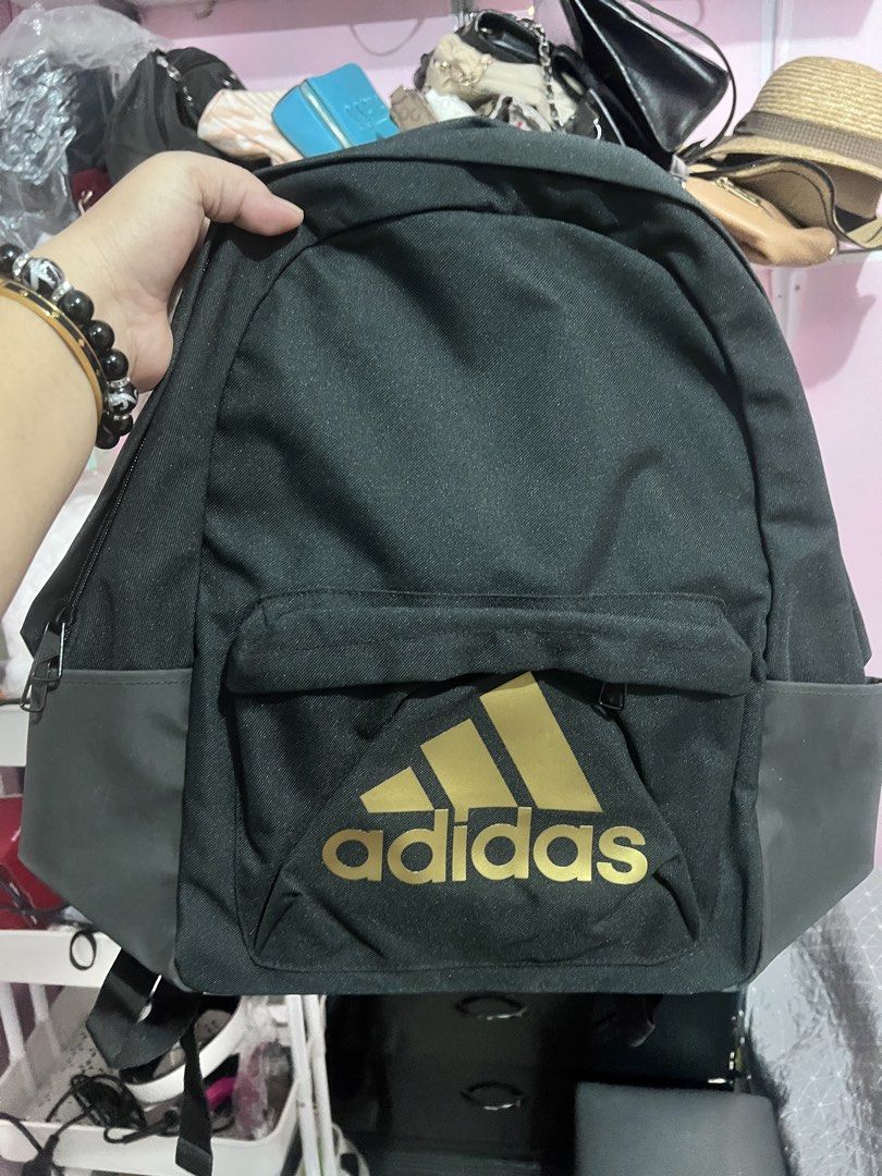 Adidas Black and Gold Backpack (Category: Backpacks) located in Manila. Submitted by cleverstone_21f597 (Listing ID 1467489565, Image 1). Description: - Brand: Adidas - Color: Black with gold logo and dark grey bottom panels - Material: Durable canvas - Compartments: Roomy main compartment and front zip pouch - Features: Adjustable shoulder straps, smooth branded zippers - Condition: Excellent / Ready for daily use - Mode of Payment: GCash, BPI, 