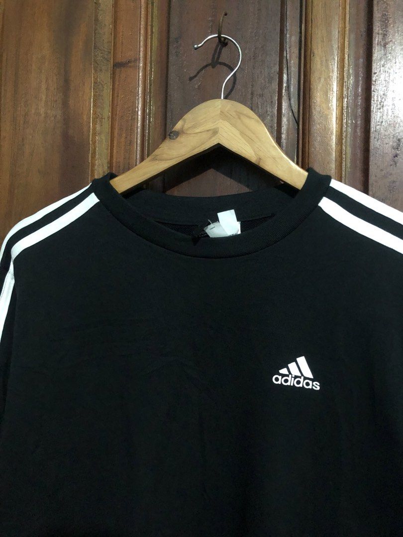 Adidas Black White Striped Sweatshirt (Category: Coats, Jackets and Outerwear) located in Quezon City. Submitted by yeahsource222 (Listing ID 1467529515, Image 2). Description: - Brand: Adidas - Color: Classic black with white stripes - Size: Medium (tag intact) - Design: Embroidered chest logo, crewneck, ribbed cuffs and hem - Condition: Clean, excellent pre-loved condition - Style: Timeless sporty look, easy to match.