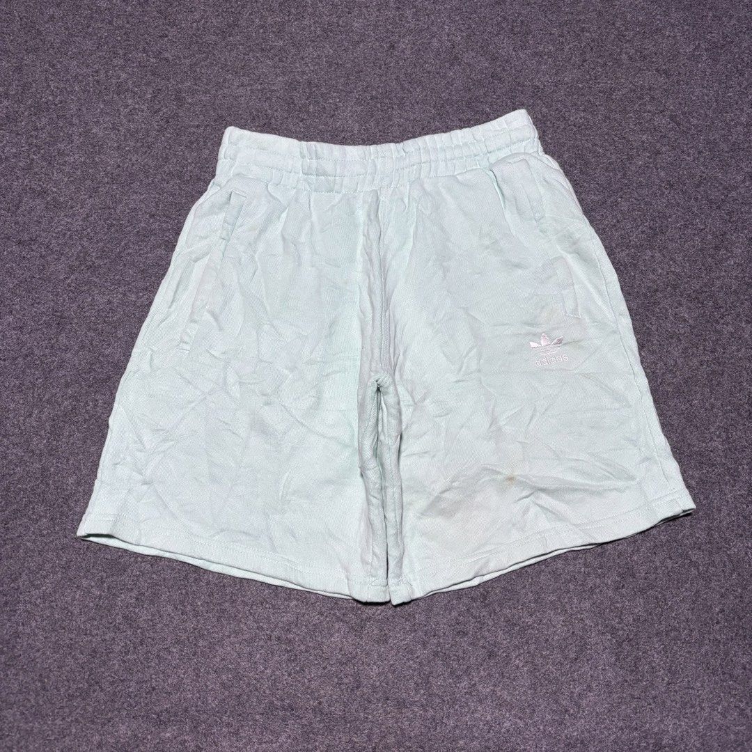 Adidas Mint Green Sweatshorts (Category: Shorts) located in Cebu City. Submitted by andrewvivar29 (Listing ID 1467443286, Image 1). Description: - Brand: Adidas - Color: Mint green - Style Code: H39974 - Material: Soft french terry inside - Features: Drawstring waistband, side pockets, embroidered Trefoil logo - Condition: Light wear with minor discoloration marks near the lower right leg - Ideal for casual lounging or workouts.