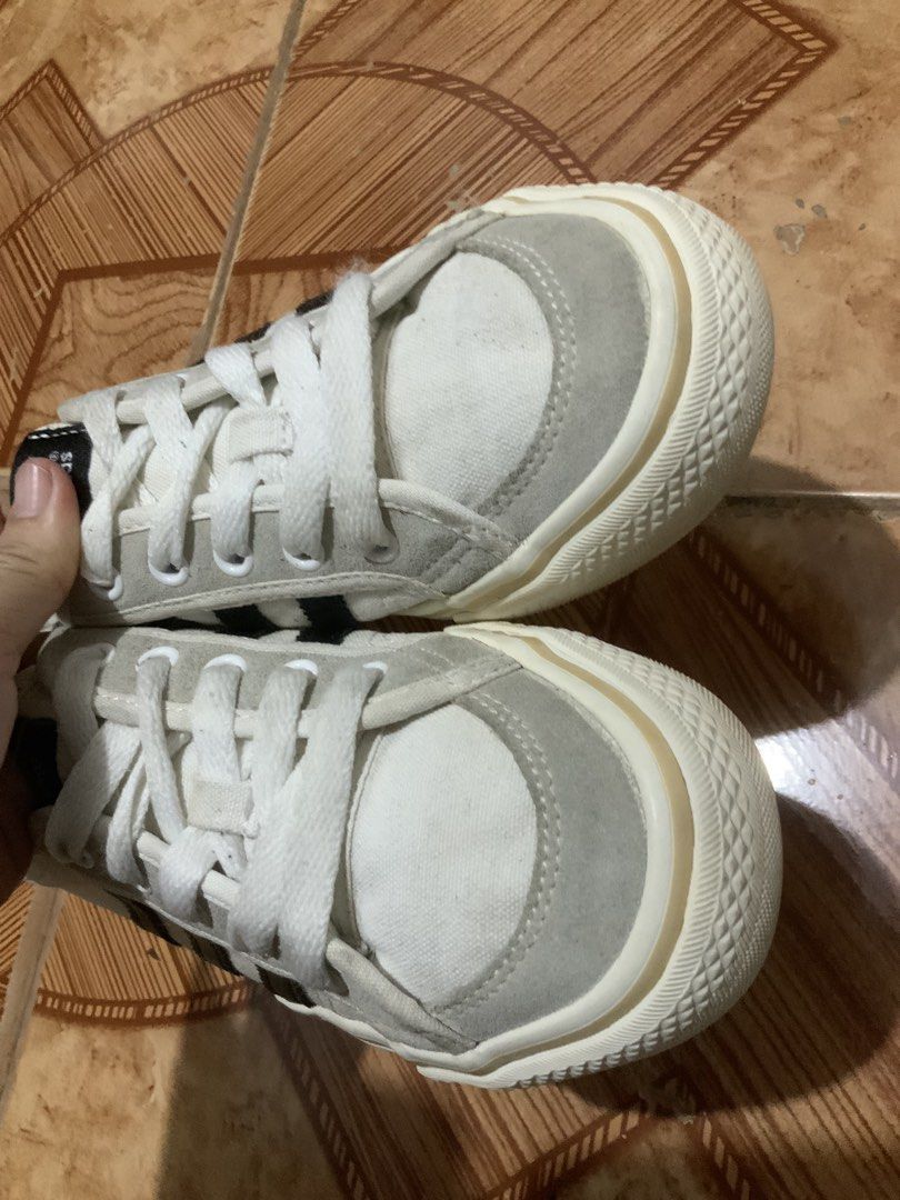 Adidas Nizza sneakers EU 38 (Category: Sneakers) located in Caloocan City. Submitted by Twinsters_2nd (Listing ID 1467448703, Image 3). Description: - Adidas Nizza low-top sneakers. - Off-white canvas upper with grey suede overlays and black three-stripes branding. - White laces and thick rubber midsoles showing mild yellowing from age. - Size EU 38, US5 - Clean overall shape with no major structural damage or heavy wear. - payment first, sh0pee 