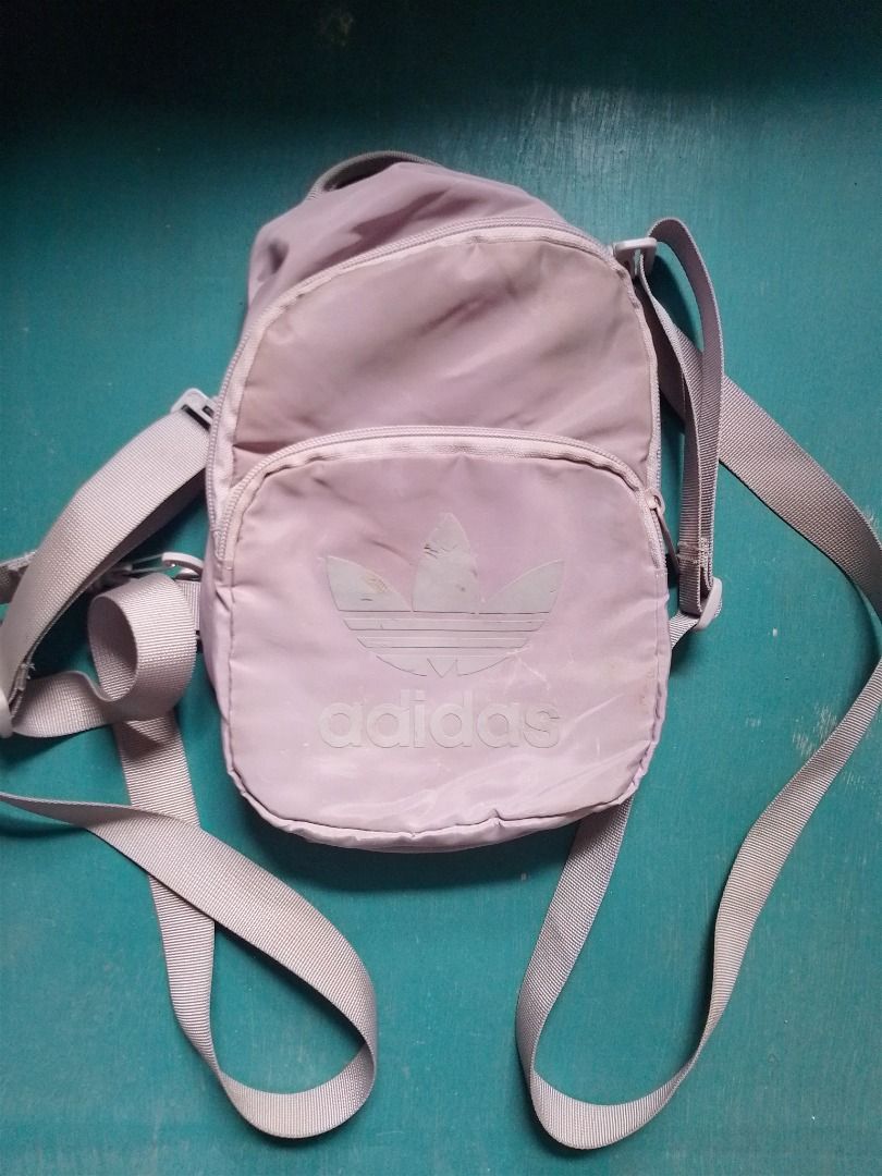 Adidas Original Pastel Purple Mini Backpack (Category: Backpacks) located in Caloocan City. Submitted by hmm_shop83 (Listing ID 1467441810, Image 1). Description: - Brand: Adidas - Color: Lilac Purple - Design: Classic trefoil logo with branded zip pull tabs - Features: Adjustable straps and secure zip closure - Origin: Made in Vietnam (RN 88387 CA 40312) - Condition: Compact size, perfect for daily commutes and casual outings.