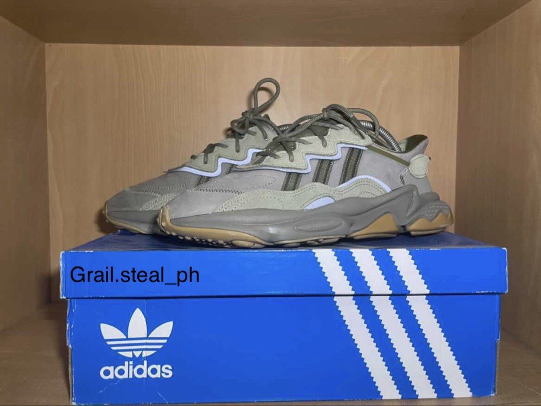 Adidas Ozweego Sneakers with Box (Category: Casual Shoes) located in Quezon City. Submitted by grail.steal_ph (Listing ID 1467388065, Image 1). Description: - Brand: Adidas - Model: Ozweego - Color: trace cargo - Sole: Chunky design with Adiprene cushioning for all-day comfort - Details: Classic three stripes branding, laces tied and ready to wear - Inclusions: Comes with original blue Adidas box - Condition: 7/10.