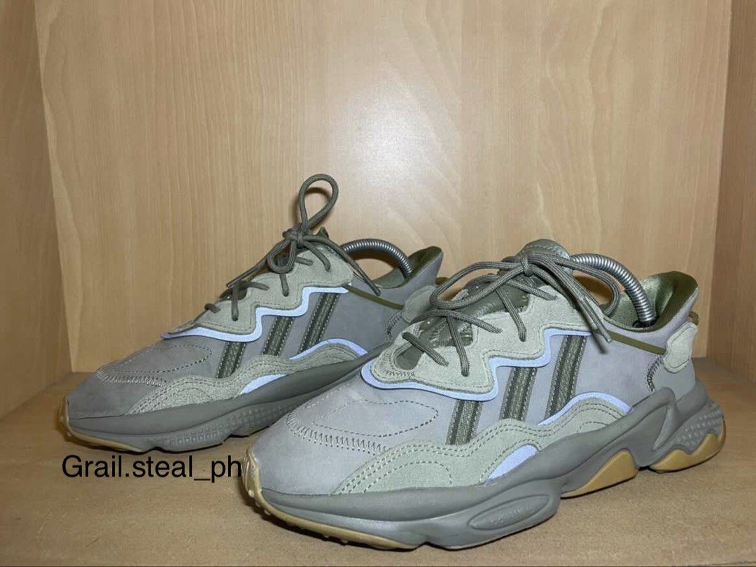 Adidas Ozweego Sneakers with Box (Category: Casual Shoes) located in Quezon City. Submitted by grail.steal_ph (Listing ID 1467388065, Image 3). Description: - Brand: Adidas - Model: Ozweego - Color: trace cargo - Sole: Chunky design with Adiprene cushioning for all-day comfort - Details: Classic three stripes branding, laces tied and ready to wear - Inclusions: Comes with original blue Adidas box - Condition: 7/10.