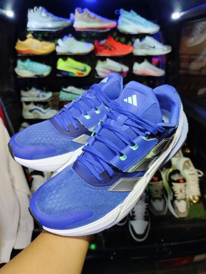 Adidas Running Shoes Blue Size 10 US (Category: Sneakers) located in Bayugan. Submitted by boss_rej (Listing ID 1467525246, Image 2). Description: - Brand: Adidas Running Shoes - Color: Vibrant blue with silver stripes and green accents - Size: US 10, UK 9.5, EUR 44 - Sole: Continental rubber outsole for superior traction and clean white midsole - Condition: Manufactured 10/22, clean, and ready for use - Versatility: Comfortable fit ideal for dai
