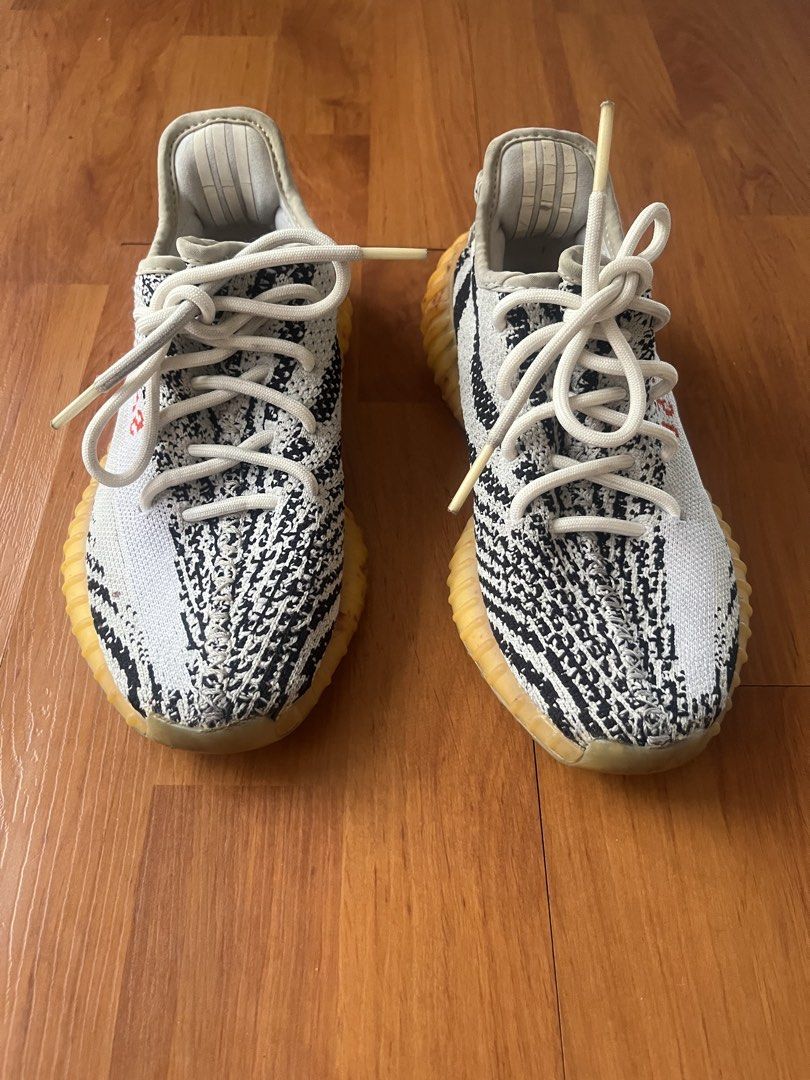 Adidas Yeezy Boost 350 V2 "Zebra" (Style Code: CP9654) (Category: Sneakers) located in Lipa City. Submitted by alexcollectionco (Listing ID 1467480343, Image 2). Description: Iconic Adidas Yeezy Boost 350 V2 in the classic “Zebra” colorway. Features a black and white Primeknit upper with lateral red “SPLY-350” text, translucent Boost-cushioned midsole, and signature pull tab. Specifications & Details: • Brand: Adidas x Yeezy • Model: Yeezy Boost 