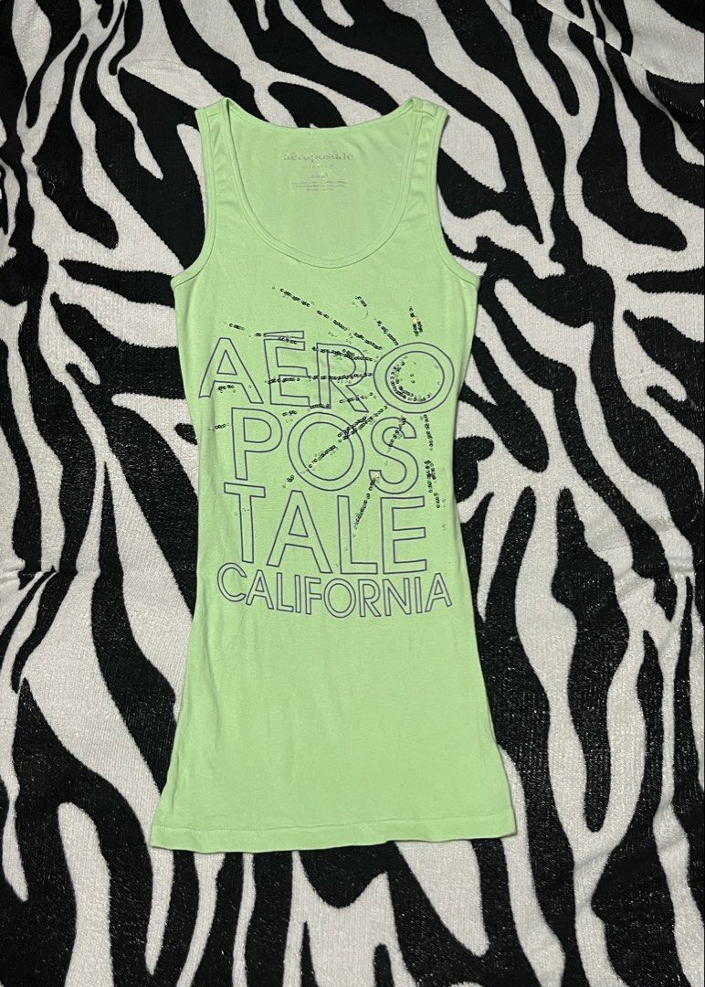 Aeropostale Stretch Green California Sequin Tank Top Medium (Category: Sleeveless) located in Manila. Submitted by y2kcloset_ (Listing ID 1467476621, Image 1). Description: - Brand: Aeropostale - Size: Medium - Color: Green - Material: Soft cotton and spandex blend with plenty of stretch - Design: 'Aeropostale California' graphic text with subtle sequin accents on the front - Neckline: Scoop neck with a comfortable tagless printed collar label - 