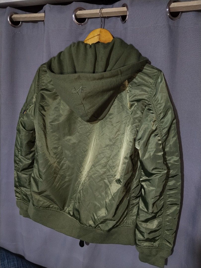 Alpha Industries MA-1 Bomber Jacket with Hood (Category: Coats, Jackets and Outerwear) located in Pasig City. Submitted by loveforlux_2025 (Listing ID 1467411955, Image 3). Description: - Brand: Alpha Industries - Color: Sage Green with classic orange lining - Features: Detachable matching hood with back logo embroidery - Details: Iconic sleeve utility pocket with red 'Remove Before Flight' style tag - Hardware: Heavy-duty branded metal zippers -