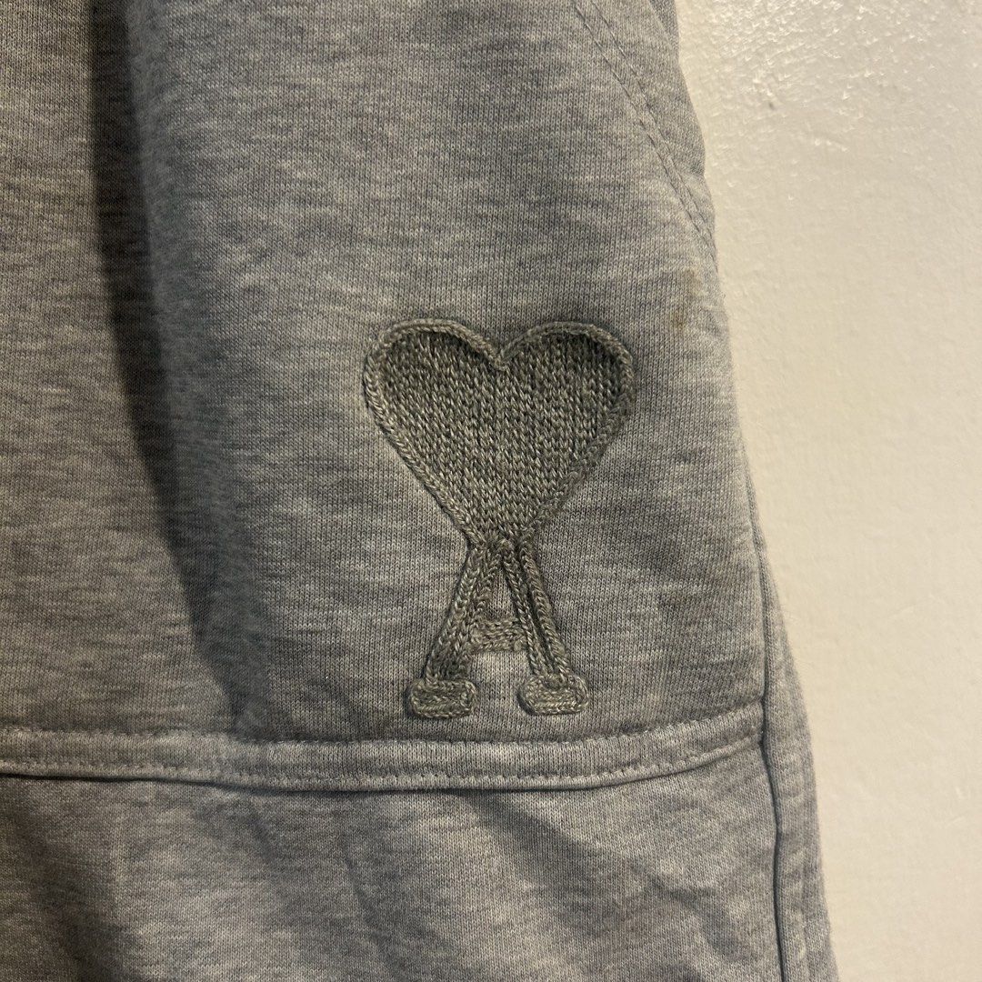 Ami Paris Grey Sweat Shorts (Category: Shorts) located in Manila. Submitted by jakes_thrift_shop (Listing ID 1467511722, Image 2). Description: - Brand: Ami Paris - Color: Grey - Material: Soft cotton French terry fabric - Fit: Casual relaxed fit - Waistband: Elastic with adjustable drawstring and metal aglets - Pockets: Large front utility patch pockets on both sides - Branding: Embroidered Ami de Coeur logo on the left pocket - Condition: Clean