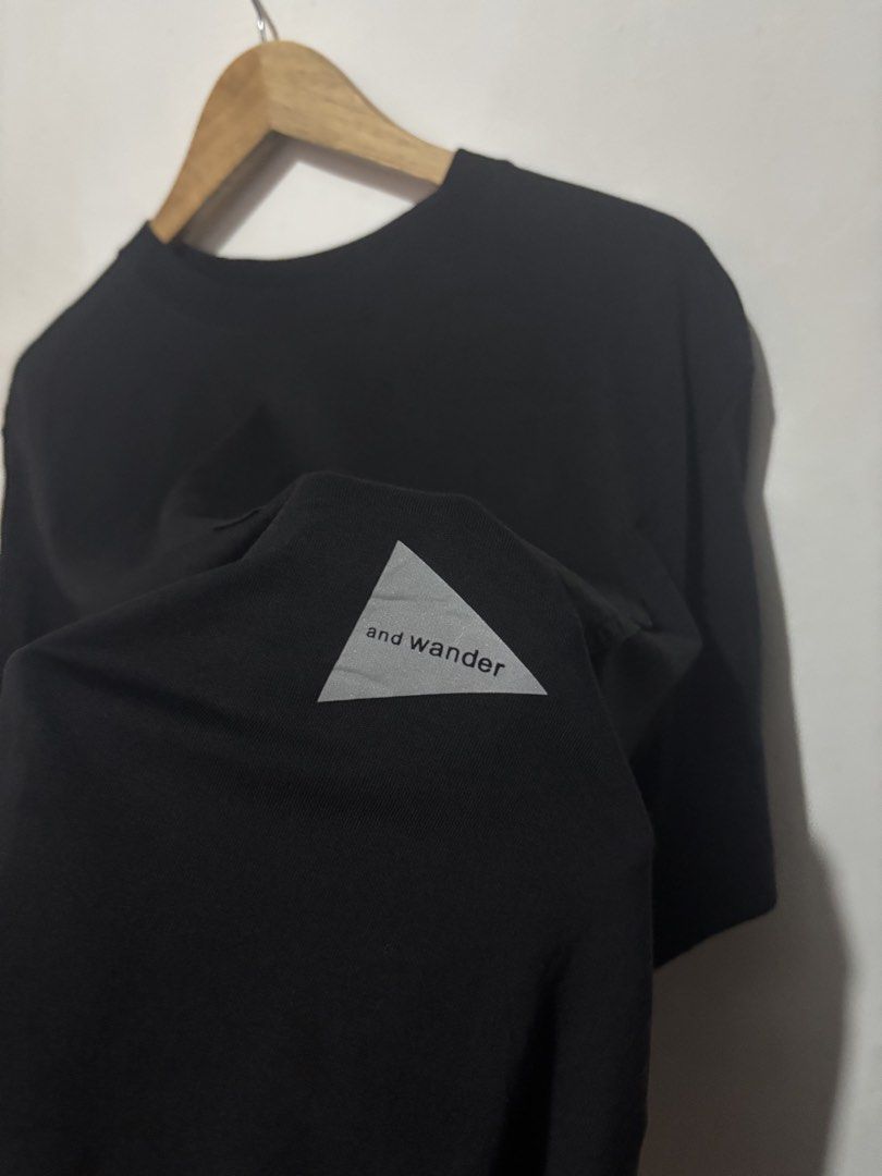 And Wander Black Pocket T-Shirt (Category: Tshirts & Polo Shirts ) located in Subic. Submitted by thriftpoison (Listing ID 1467410064, Image 3). Description: - Brand: and wander - Size : 1 Length 28 Width 23 - Color: Classic black - Sleeve: Short sleeve - Pocket: Contrast utility pocket on left chest with branded snap button - Details: Reflective triangle logo on lower left front; inspiring quote printed inside the collar - Back: Clean, solid des