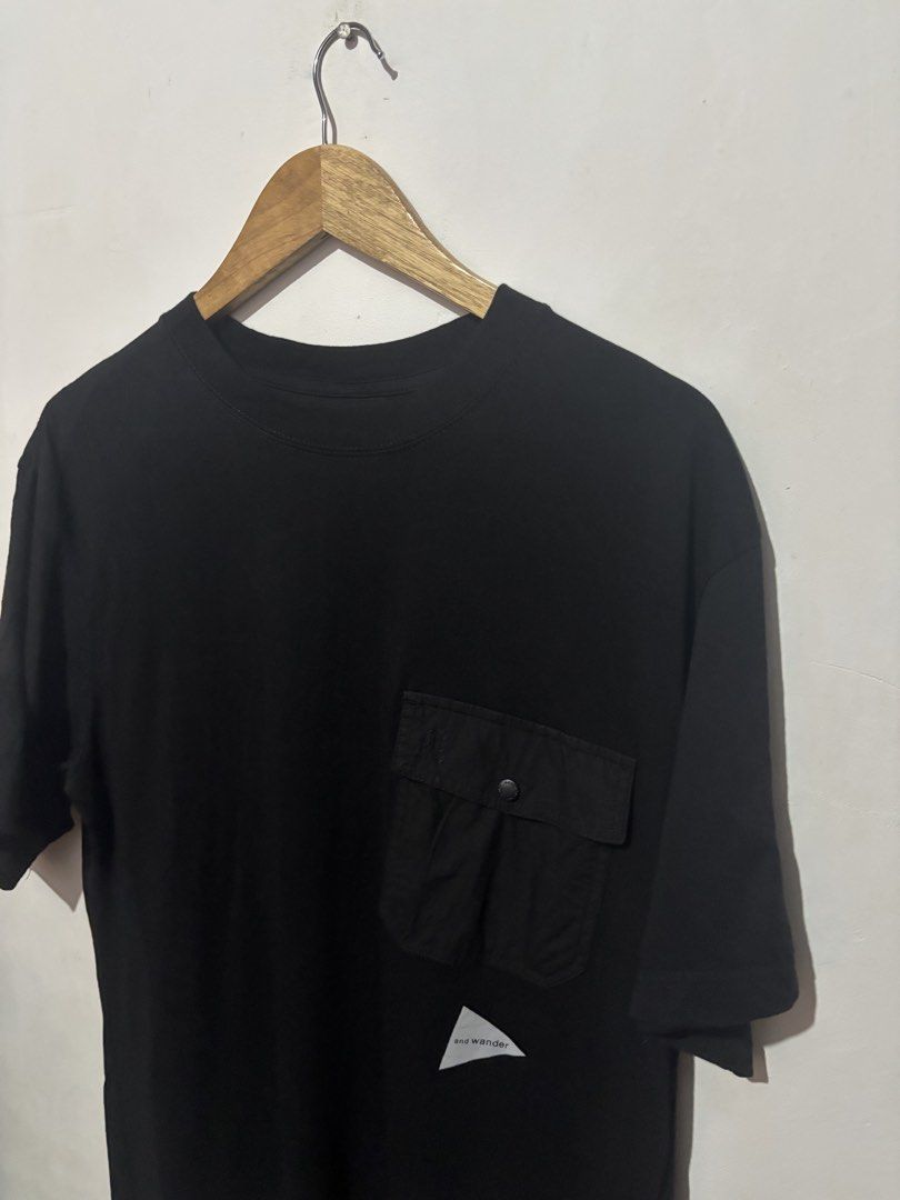 And Wander Black Pocket T-Shirt (Category: Tshirts & Polo Shirts ) located in Subic. Submitted by thriftpoison (Listing ID 1467410064, Image 2). Description: - Brand: and wander - Size : 1 Length 28 Width 23 - Color: Classic black - Sleeve: Short sleeve - Pocket: Contrast utility pocket on left chest with branded snap button - Details: Reflective triangle logo on lower left front; inspiring quote printed inside the collar - Back: Clean, solid des