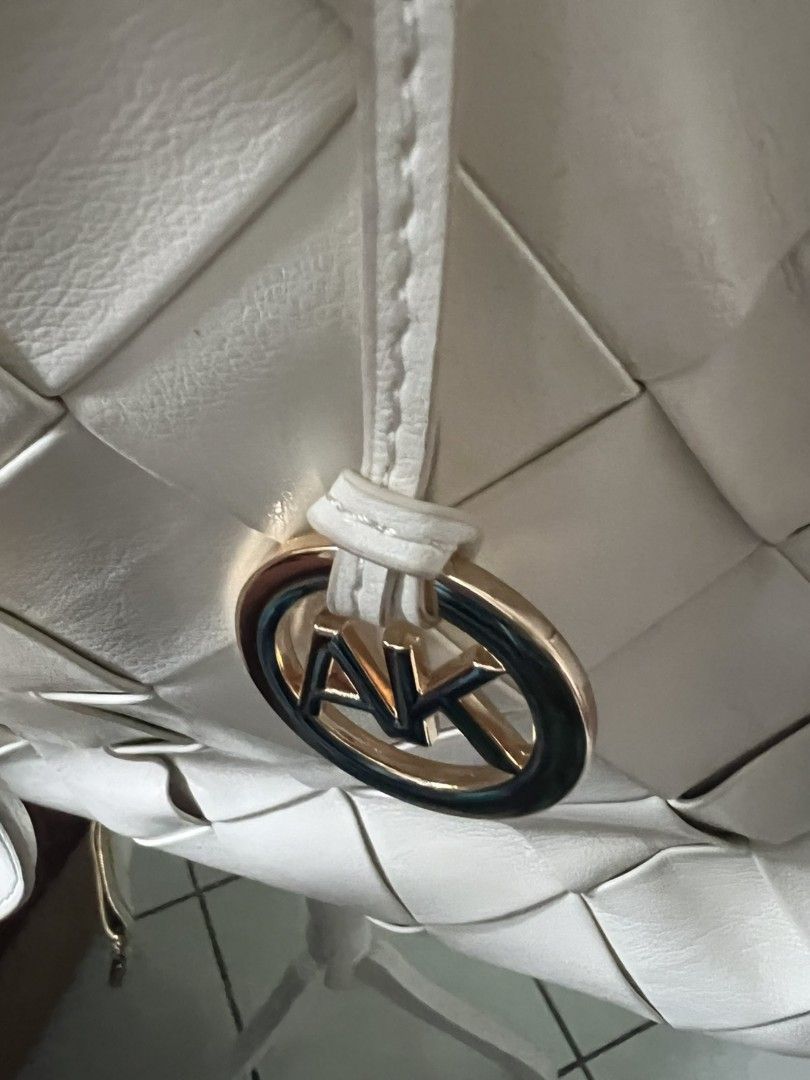 Anne Klein White Woven Tote Bag with Pouch (Category: Tote Bags) located in Manila. Submitted by momshei123 (Listing ID 1467366229, Image 1). Description: - Brand: Anne Klein - Color: Clean white with textured grid pattern - Material: Premium synthetic leather - Inclusions: Matching small zipper pouch - Straps: Dual top handles + detachable, adjustable crossbody strap - Hardware: Elegant round gold logo charm - Interior: Spacious enough for daily