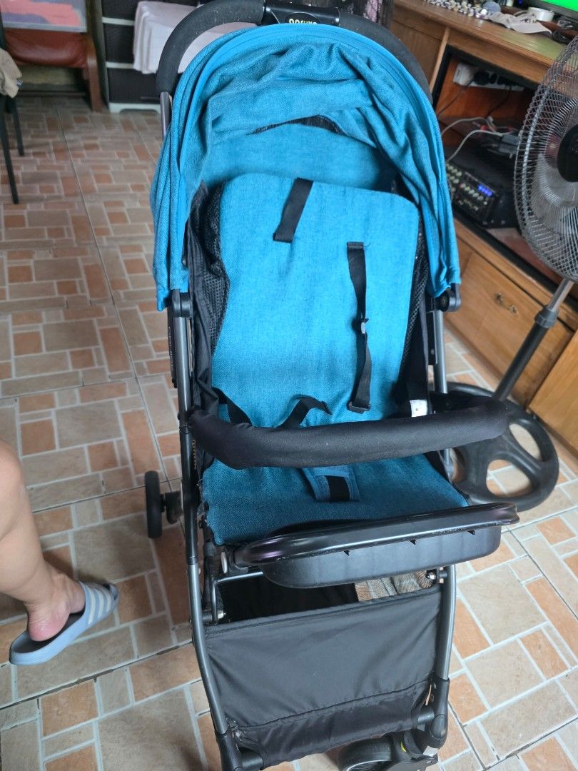 Apruva Blue and black foldable baby stroller with canopy (Category: Strollers) located in Taguig. Submitted by dilyndelro36287 (Listing ID 1467475433, Image 2). Description: - Stylish blue fabric seat with matching canopy - Sturdy black frame with secure safety straps - Convenient storage basket underneath for bags and baby essentials - Compact fold design for easy storage and transport - Comfortable padded push handle for daily walks and trips o