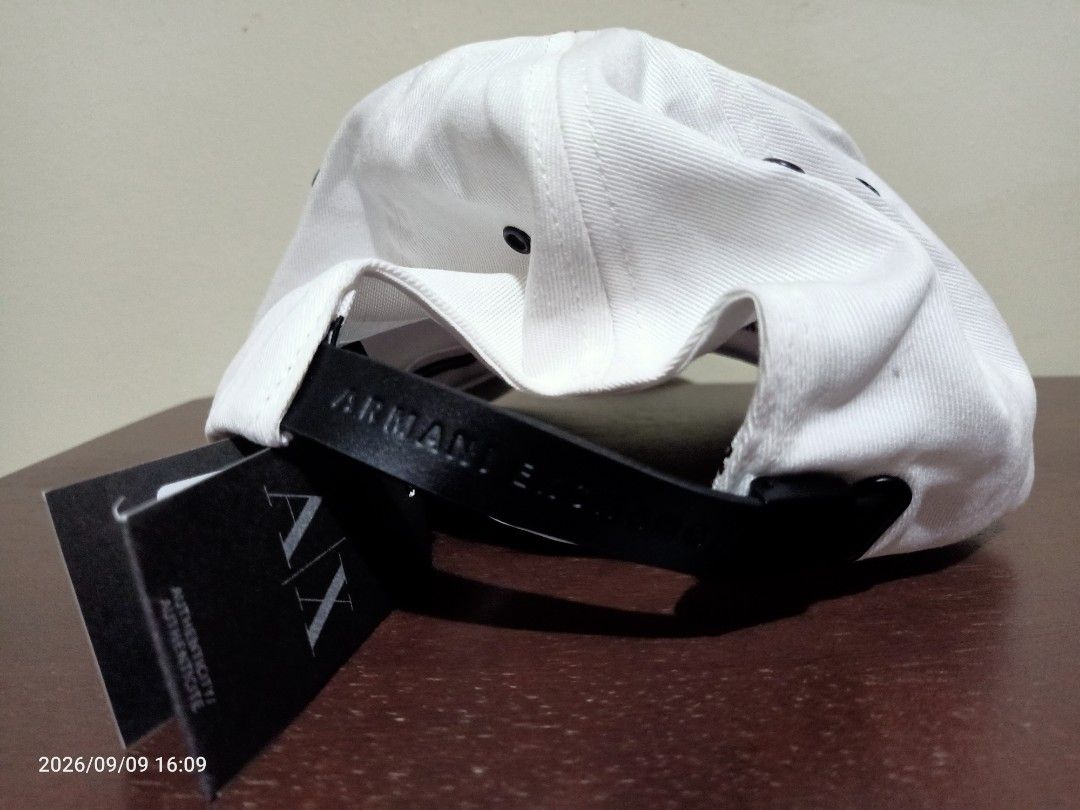 Armani Exchange Cap (Category: Caps & Hats) located in Las Pinas. Submitted by OmengSoyT (Listing ID 1467523071, Image 2). Description: - Brand: Armani Exchange - Color: Crisp white with bold embroidered logo - Material: 100% comfortable cotton - Strap: Adjustable black leather strap with debossed branding - Details: Interior taping with repeated Armani Exchange lettering - Condition: Brand new, never worn, with original tags still attached. Guar