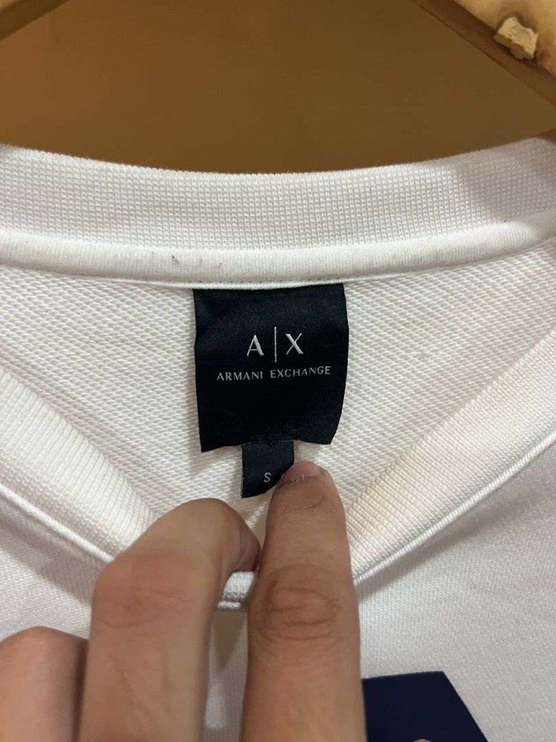 Armani Exchange white crewneck sweatshirt (Category: Luxury Apparel) located in Quezon City. Submitted by michypeachyy1 (Listing ID 1467547225, Image 3). Description: 2500 plus ship medium size removable stain.