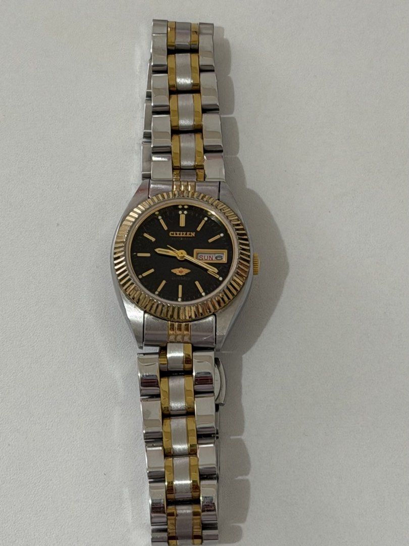 Authentic Citizen Eagle 7 Watch (Black) (Category: Women's Watches) located in Manila. Submitted by zenovia.r (Listing ID 1467439722, Image 1). Description: Fake strap, original bezel and dial. Not working; needs a battery replacement. Can ship ASAP. - Brand: Citizen - Design: Two-tone silver and gold stainless steel bracelet with fluted gold-tone bezel - Dial: Classic black dial with a convenient day and date window at 3 o'clock - Movement & Mod