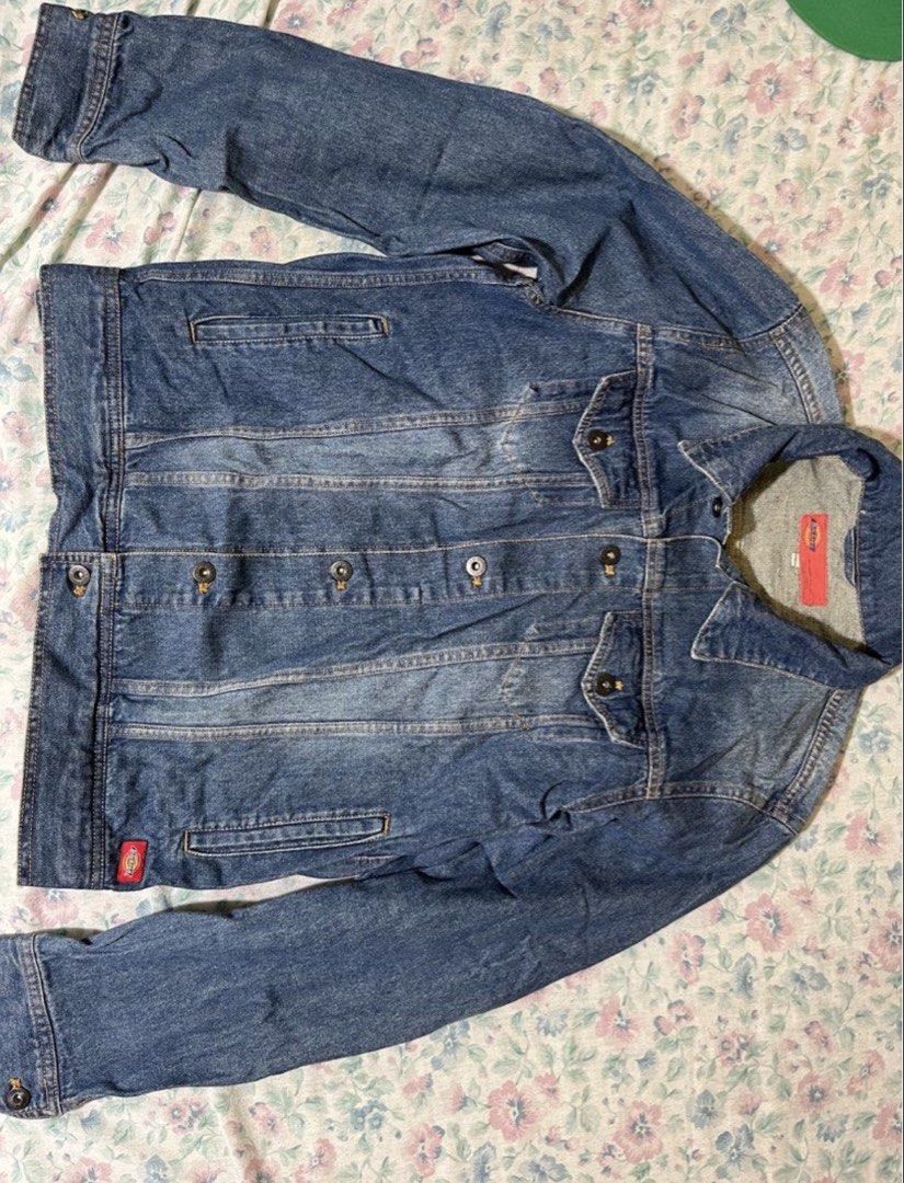 Authentic Dickies Men's Blue Denim Trucker Jacket (Category: Coats, Jackets and Outerwear) located in Manila. Submitted by jeymzeruuu (Listing ID 1467418263, Image 2). Description: - Brand - Authentic Dickies branding featured on the interior neck label, external side tab, and metal buttons. - Design - Classic trucker-style jacket with a medium-blue wash, button-front closure, and dual chest pockets. - Size - Tagged as size Large (L). - Condition