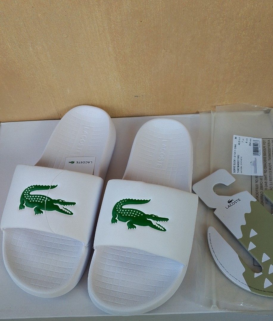 Authentic Lacoste Serve Slides (Category: Slippers & Slides) located in Lipa City. Submitted by meechytwotwotwo (Listing ID 1467428458, Image 1). Description: • Lacoste Serve Slides - Size: 40.5 EUR / 7 UK / 8 US / 254 MM - White / Green Synthetic - Brandnew Plss check photos for actual condition additional shipping fee MODE OF PAYMENT: GCASH/NO COD payment first before shipment Thank you..