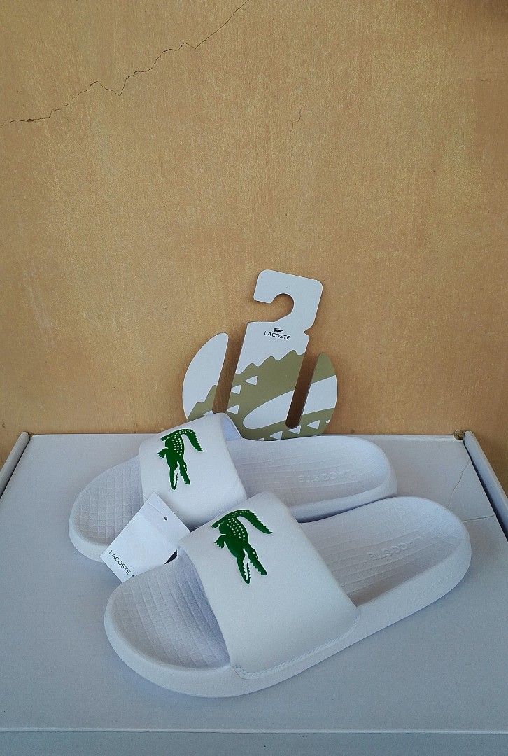 Authentic Lacoste Serve Slides (Category: Slippers & Slides) located in Lipa City. Submitted by meechytwotwotwo (Listing ID 1467428458, Image 2). Description: • Lacoste Serve Slides - Size: 40.5 EUR / 7 UK / 8 US / 254 MM - White / Green Synthetic - Brandnew Plss check photos for actual condition additional shipping fee MODE OF PAYMENT: GCASH/NO COD payment first before shipment Thank you..