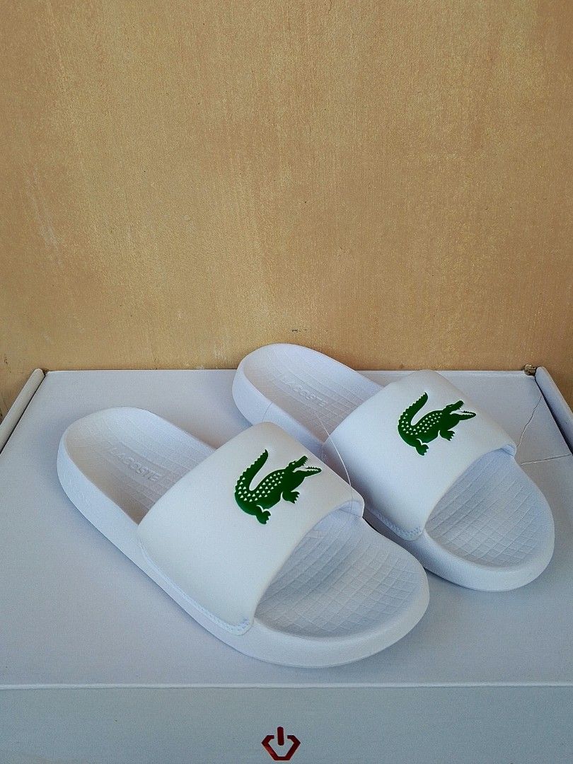 Authentic Lacoste Serve Slides (Category: Slippers & Slides) located in Lipa City. Submitted by meechytwotwotwo (Listing ID 1467428458, Image 3). Description: • Lacoste Serve Slides - Size: 40.5 EUR / 7 UK / 8 US / 254 MM - White / Green Synthetic - Brandnew Plss check photos for actual condition additional shipping fee MODE OF PAYMENT: GCASH/NO COD payment first before shipment Thank you..