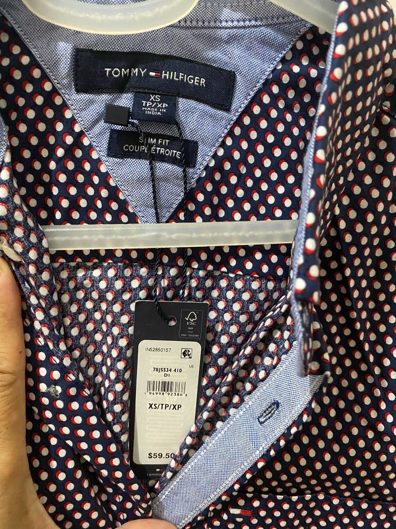 Authentic Tommy Hilfiger Men's Burgundy Patterned Short Sleeve Button down (Category: Tshirts & Polo Shirts ) located in Quezon City. Submitted by SustainableFashionatbp (Listing ID 1467492935, Image 3). Description: - Brand: Tommy Hilfiger - Color: Burgundy with a small geometric dot pattern - Style: Short sleeve, button-down front with a standard collar - Versatility: Easy to style for both casual days and smart-casual office wear - Fit: True t