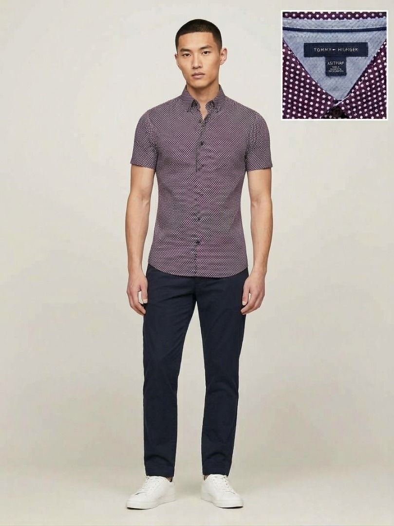 Authentic Tommy Hilfiger Men's Burgundy Patterned Short Sleeve Button down (Category: Tshirts & Polo Shirts ) located in Quezon City. Submitted by SustainableFashionatbp (Listing ID 1467492935, Image 1). Description: - Brand: Tommy Hilfiger - Color: Burgundy with a small geometric dot pattern - Style: Short sleeve, button-down front with a standard collar - Versatility: Easy to style for both casual days and smart-casual office wear - Fit: True t