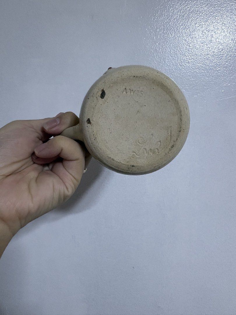 AWIS Handmade ceramic mug with design (Category: Coffee & Tea Tableware) located in Caloocan City. Submitted by candysam2000 (Listing ID 1467375375, Image 3). Description: Item: - Handmade ceramic mug with speckled beige glaze - Unique sculptural bust detail with painted red tips - Stamped 'AWIS' on the bottom - Comfortable solid side handle - Features charming, normal handcrafted character throughout - Great conversation piece for your morning c