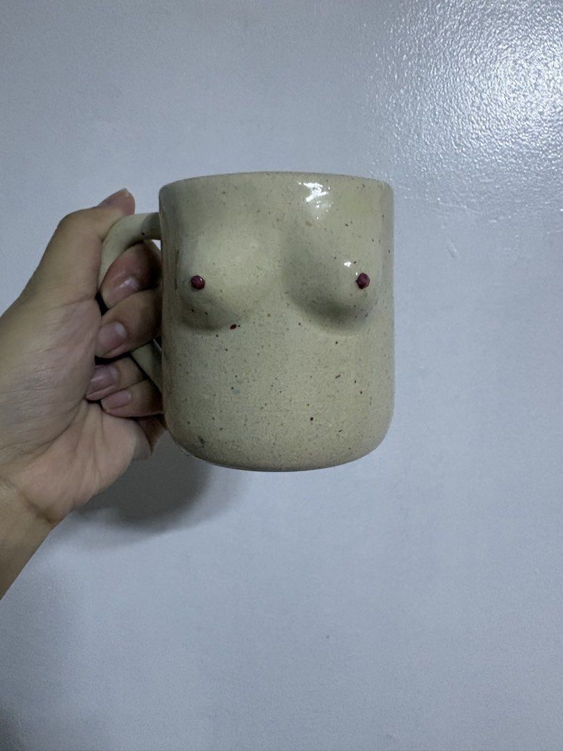 AWIS Handmade ceramic mug with design (Category: Coffee & Tea Tableware) located in Caloocan City. Submitted by candysam2000 (Listing ID 1467375375, Image 1). Description: Item: - Handmade ceramic mug with speckled beige glaze - Unique sculptural bust detail with painted red tips - Stamped 'AWIS' on the bottom - Comfortable solid side handle - Features charming, normal handcrafted character throughout - Great conversation piece for your morning c
