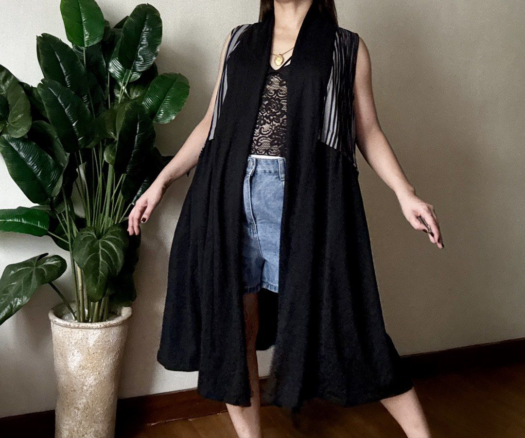 Baking Soda Long Black Sleeveless Vest (Category: Sleeveless) located in Mandaluyong City. Submitted by roxieeeeeee (Listing ID 1467492717, Image 1). Description: - Brand/Origin: Baking Soda, Made in Korea - Style: Sleeveless long vest with open front and draped lapel - Design: Contrasting black, grey, and white striped pleated panels on upper sides - Features: Two deep side pockets - Fabric: Lightweight, ideal for layering over tanks and dresses