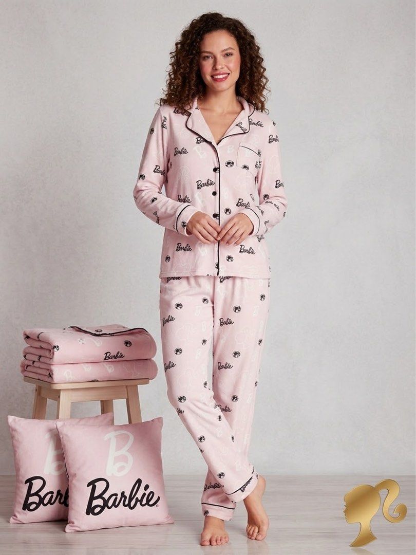 Barbie pink pajama set long sleeve button up (Category: Undergarments & Loungewear) located in Pasuquin. Submitted by licashop.ph (Listing ID 1467379520, Image 1). Description: - Pink Barbie fleece pajama set -fits M-L - Long-sleeve top with black piping, buttons, and chest pocket - Matching pants with elastic drawstring waist - Soft and cozy high quality material covered in Barbie script and silhouette logos - Ideal for lounging or sleeping.