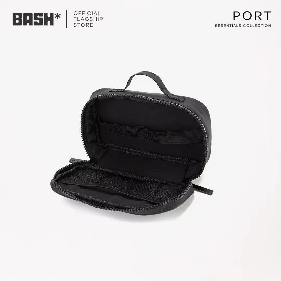 BASH PORT Essentials Collection Toiletry Bag (Category: Purses & Pouches) located in Paranaque City. Submitted by lizzymutia (Listing ID 1467372383, Image 3). Description: - Brand/Collection: BASH PORT Essentials - Price: Affordable & High Quality - Colors Available: Bone/White - Dimensions: Compact 18cm x 10cm x 5cm size - Material: Durable, water-resistant nylon - Features: Multiple interior mesh pockets and elastic loops for easy organization 