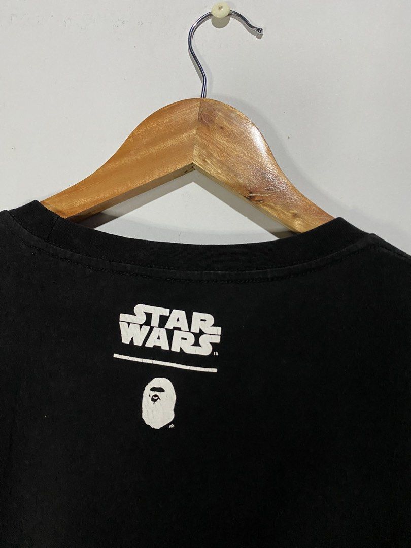 BATHING APE STARWARS TSHIRT (Category: Tshirts & Polo Shirts ) located in Jaen. Submitted by oshimamark58418 (Listing ID 1467538130, Image 2). Description: - Brand: A Bathing Ape (BAPE) x Star Wars - Color: Black - Size: Tagged XL, but measures approx. 22" x 26" (fits like Men's Medium) - Design: Unique front graphic featuring Star Wars droids and BAPE head, plus Star Wars branding on the back collar - Details: Signature BAPE sleeve tag included 