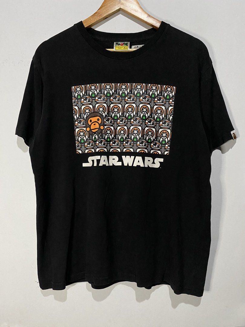 BATHING APE STARWARS TSHIRT (Category: Tshirts & Polo Shirts ) located in Jaen. Submitted by oshimamark58418 (Listing ID 1467538130, Image 1). Description: - Brand: A Bathing Ape (BAPE) x Star Wars - Color: Black - Size: Tagged XL, but measures approx. 22" x 26" (fits like Men's Medium) - Design: Unique front graphic featuring Star Wars droids and BAPE head, plus Star Wars branding on the back collar - Details: Signature BAPE sleeve tag included 