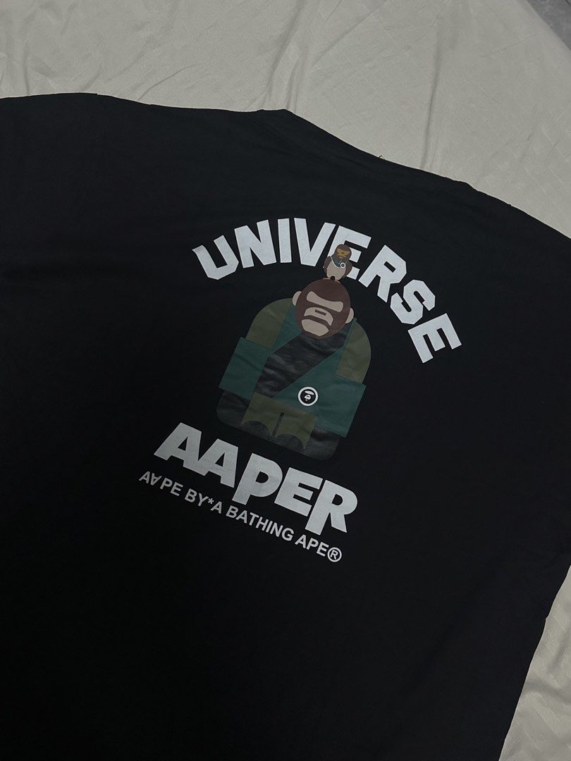BATHING APE Universe Black T-Shirt (Category: Tshirts & Polo Shirts ) located in Manila. Submitted by jmdrgooddeals (Listing ID 1467378850, Image 3). Description: - Brand: AAPE by A Bathing Ape - Color: Black - Size: L (fits standard) - Condition: Brand new with tags (BNWT) - Origin: Made in Japan - Design: Iconic ape head logo on the front; large 'UNIVERSE' and 'AAPER' graphic print on the back - Quality: Clean graphics with zero cracking.